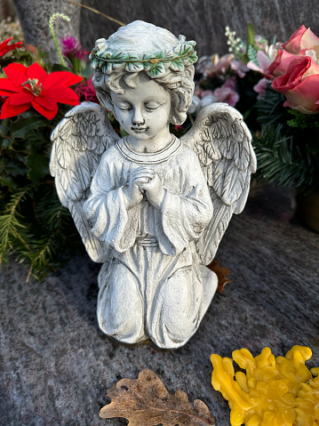 Angel figurine on a tombstone in the public cemetery