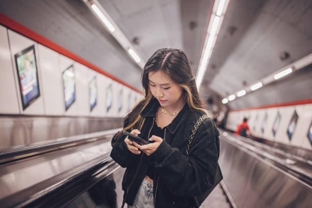 istock Woman on escalator in subway station 1851827735