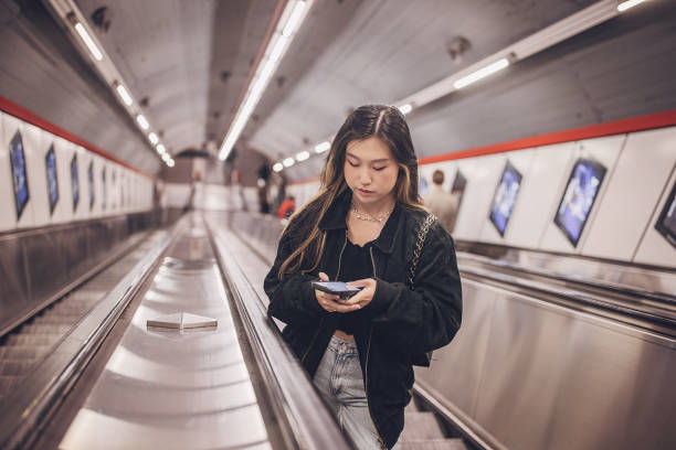istock Woman on escalator in subway station 1851828785