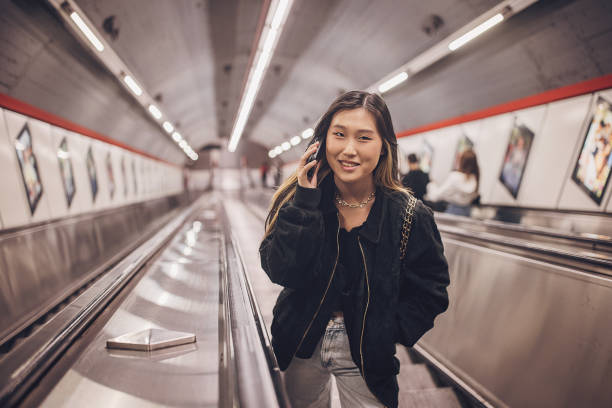 istock Woman on escalator in subway station 1851829838