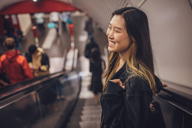istock Woman on escalator in subway station 1851831946