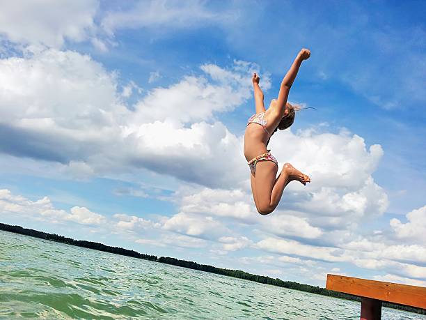 istock Girl jumping into the lake. 185184391