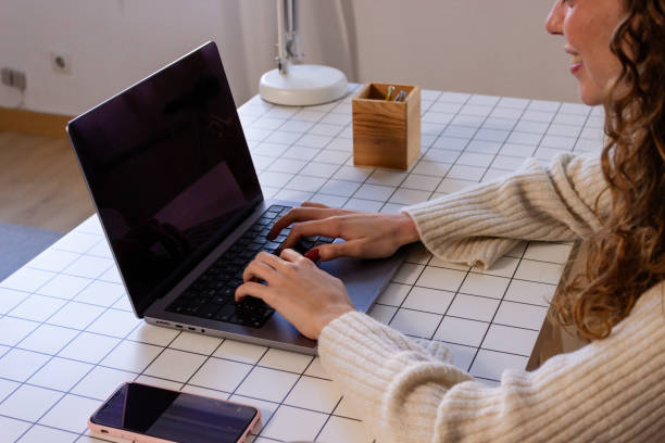 istock Young woman working on a laptop at home. Remote work concept. 1851844924