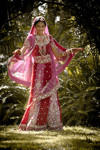 istock Young indian bride dancing in traditional bridal gown 185184748