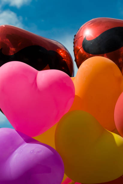 istock Multi-coloured heart balloons with blue sky background 1851849939
