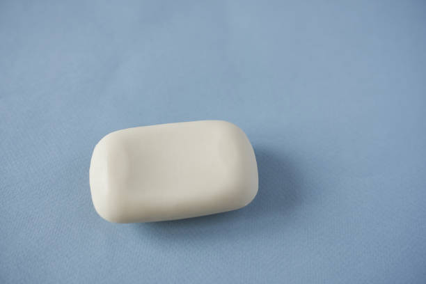 istock Bar of soap on blue background, close-up, selective focus 1851860741