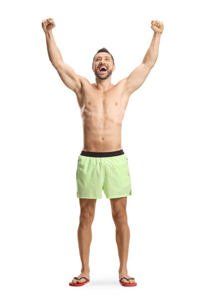 Young man in swimming shorts gesturing happiness isolated on white background