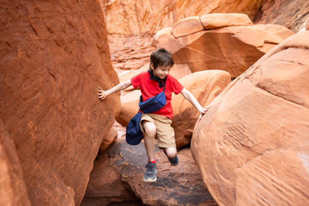 Boy Climbing Rocks in Arches National Park, Utah