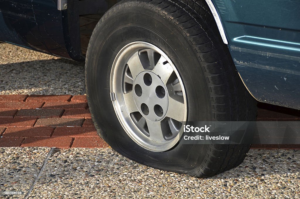 flat tire Vehicle on road with a flat tire. Concepts Stock Photo