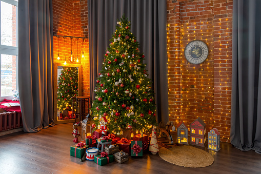 Happy New Year and Christmas! New Year's interior in loft style, green Christmas tree and classic decorations
