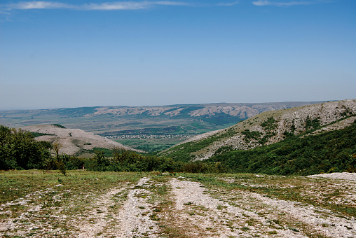 Mountainous area of the Crimean peninsula, a populated area is visible in the plain.