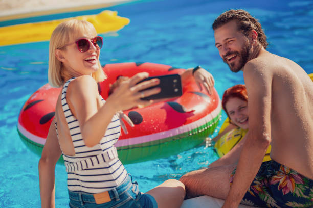 istock Friends taking a selfie at the swimming pool 1851921158