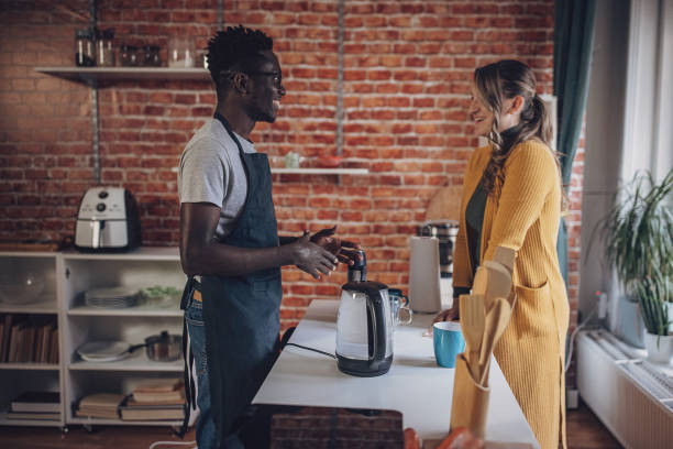 istock Young Couple Preparing Morning Tea 1851924996