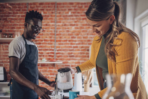 istock Young Couple Preparing Morning Tea 1851927233