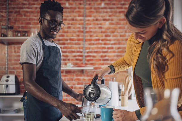 istock Young Couple Preparing Morning Tea 1851927819