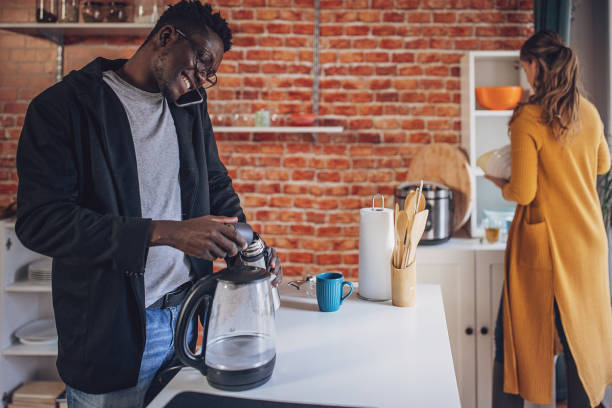 istock Young Diverse Couple Joyful Kitchen Coffee Time 1851930958
