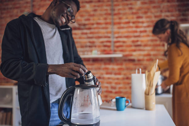 istock Young Diverse Couple Joyful Kitchen Coffee Time 1851931159