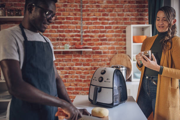 istock Interracial Couple Cooking Together in Beautiful Kitchen 1851936941