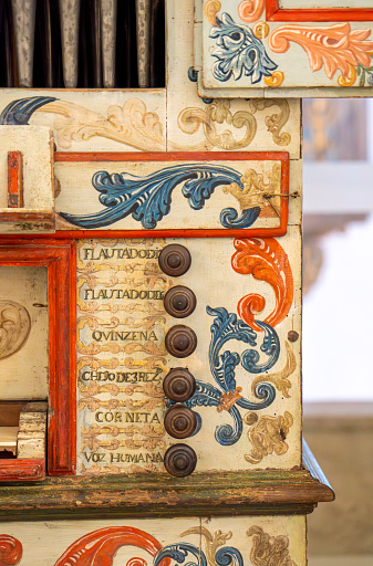 Detail of commands and buttons of a restored organ decorated with painted floral motifs from the Church of San Francisco in Évora, built in 1742.