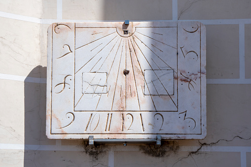 Medieval sundial in marble stone with sculpted and engraved numbers from the church of San Francisco de Evora in Portugal.
