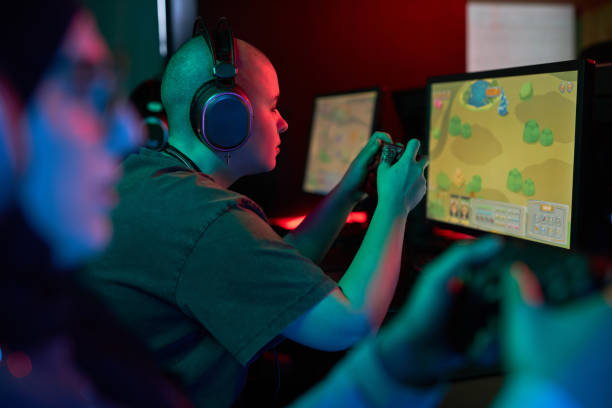 istock Woman Holding Gaming Controller and Playing Video Games 1851951196
