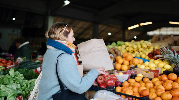istock Woman using paper bag during grocery shopping 1851970762