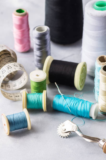 istock Tailor sewing accessories, craft concept background, scissors, tracing wheel, measure, threads 1851975039