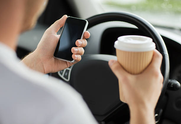 istock close up of man using phone while driving the car 185200641