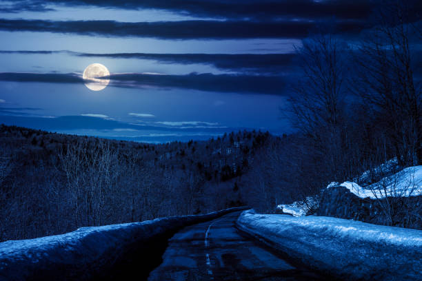 istock pass with snow on the roadside at night 1852011879