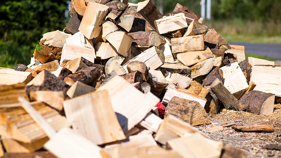 A large pile of beautifully cut wood on a light background.