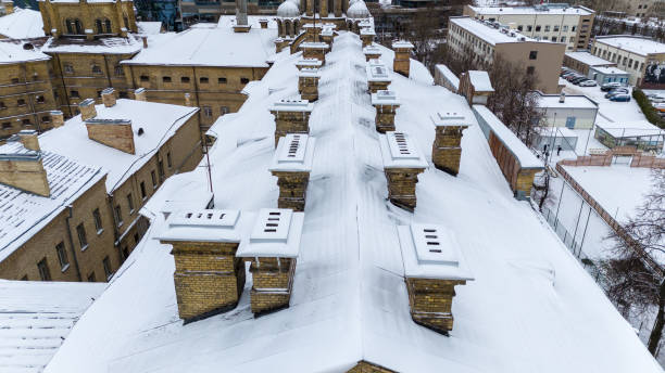 Drone photography of old prison rooftop with chimneys during winter day