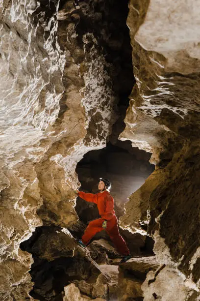 Photo of A portrait of a young female caver exploring the cave