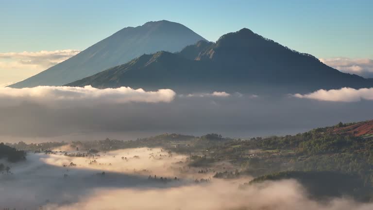 Aerial Drone of Pinggan Sunrise View Pohon Cinta, mt. Batur and mt. Agung With Moving Fog and Cloud, Kintamani, Kabupaten Bangli, Bali, Indonesia