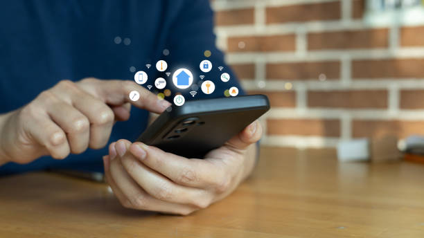 istock close up man hols smartphone and using home automation function for looking and monitor inside or outside home and property for ai innovation future concept 1852047905