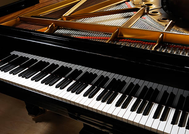 Grand piano Classical black grand piano with keyboard in foreground. More piano pictures... grand piano stock pictures, royalty-free photos & images