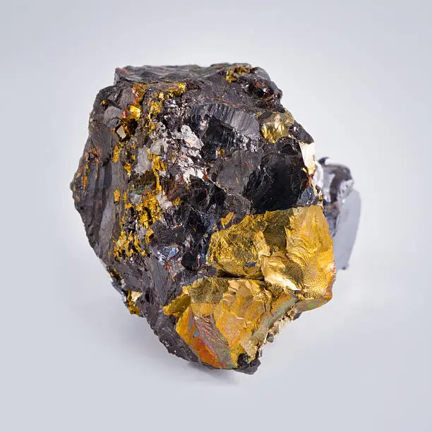 "Chalcopyrite mineral, isolated on grey"