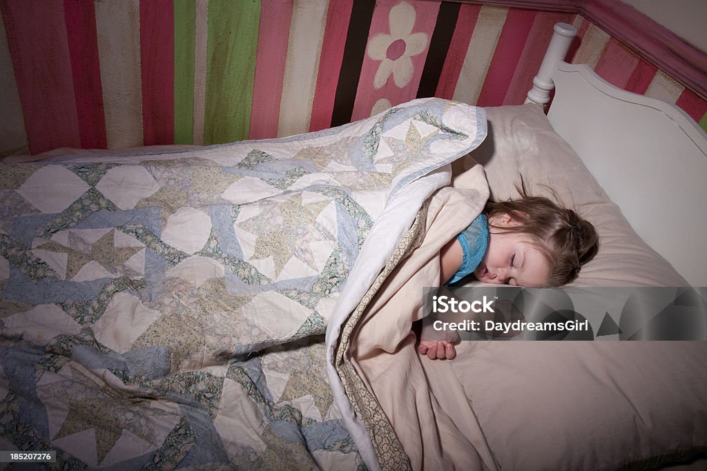 Sleeping Child in Bed Little sleeping peacefully in her bed. Child Stock Photo