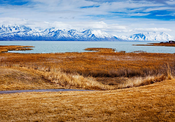 View of Utah Lake and the Wasatch Mountains "View of Utah Lake and the Wasatch Mountains in Utah County, taken from Saratoga Springs in February 2012." lake utah stock pictures, royalty-free photos & images