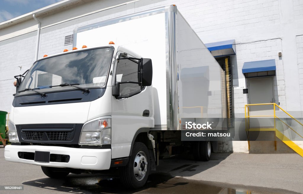Delivery truck at dock. Nice white delivery truck park at a dock wharehouse. Loading Dock Stock Photo
