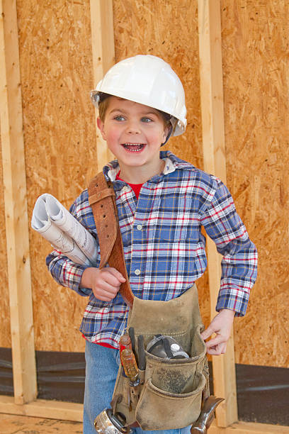 istock Boy With Tool Belt & Hardhat Standing In New Home Construction 185209185