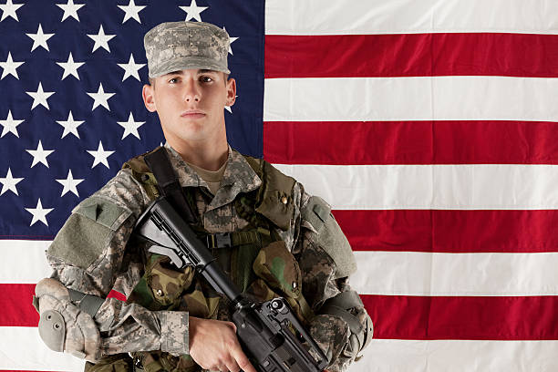 istock Army man standing in front of American flag 185209190