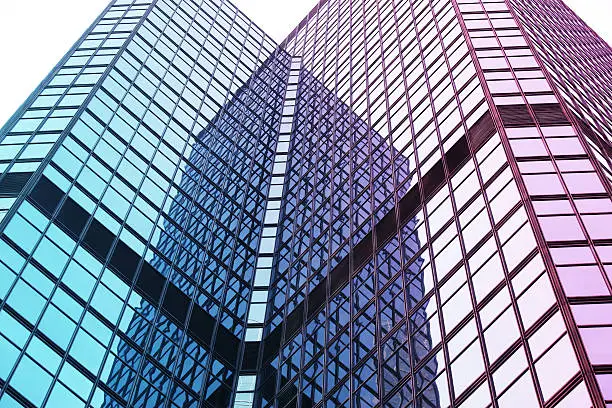 Interesting reflection and lines formed by two modern glass architecture.