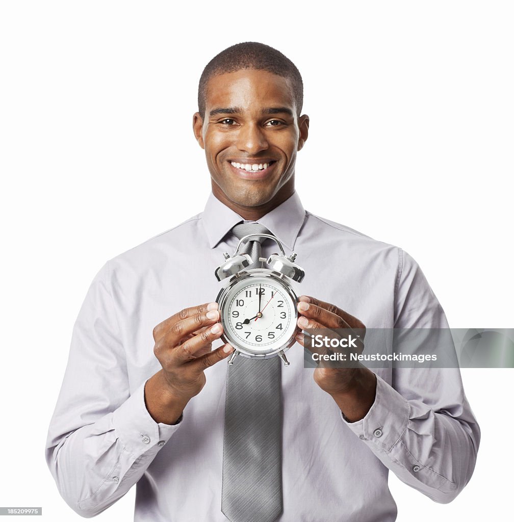 Businessman Holding an Alarm Clock - Isolated Portrait of a young businessman holding up an alarm clock. Horizontal shot. Isolated on white. 20-29 Years Stock Photo