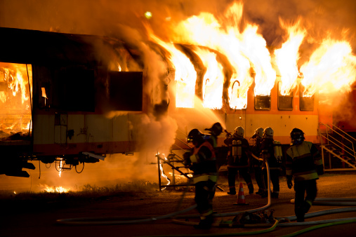 fire fighters extinguishing the fire on a train - some motion blur