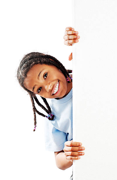 istock Little girl peeking behind Whiteboard. 185210494