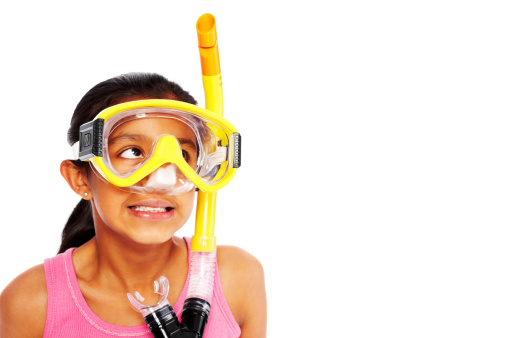 Image of innocent little girl wearing snorkel looking away at copyspace against white background