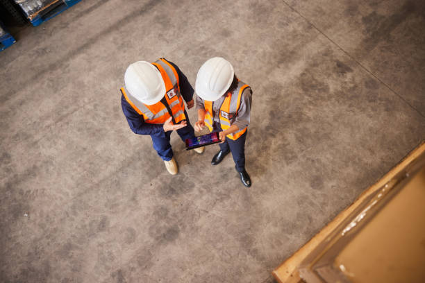 istock Two engineers using a tracing app on the floor of a distribution warehouse 1852108488