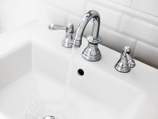 Bathroom sink and faucet Running water in Bathroom sink. bathroom sink photos stock pictures, royalty-free photos & images