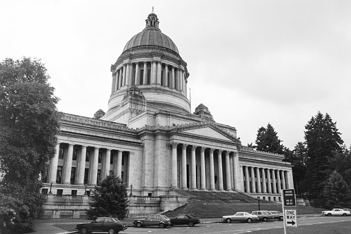 Grainy archival black and white film photograph of the Washington State Capitol Building with cloudy sky.  Shot May 1992.