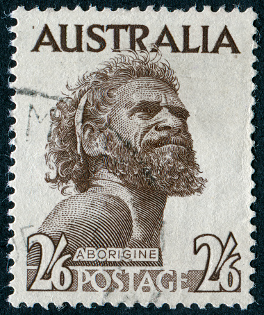 An Australian postage stamp featuring a portrait of Gwoya Tjungurrayi, an Australian Aboriginal man of the Warlpiri and Anmatyerr peoples, 1950.